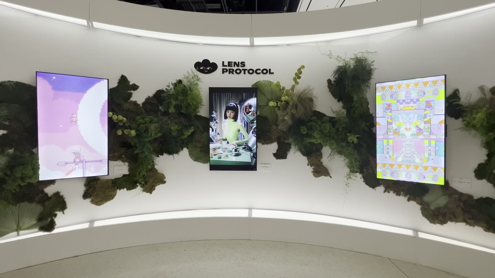 Wheel of Internet on screen among plants on the Lens Protocol wall at Gateway Miami